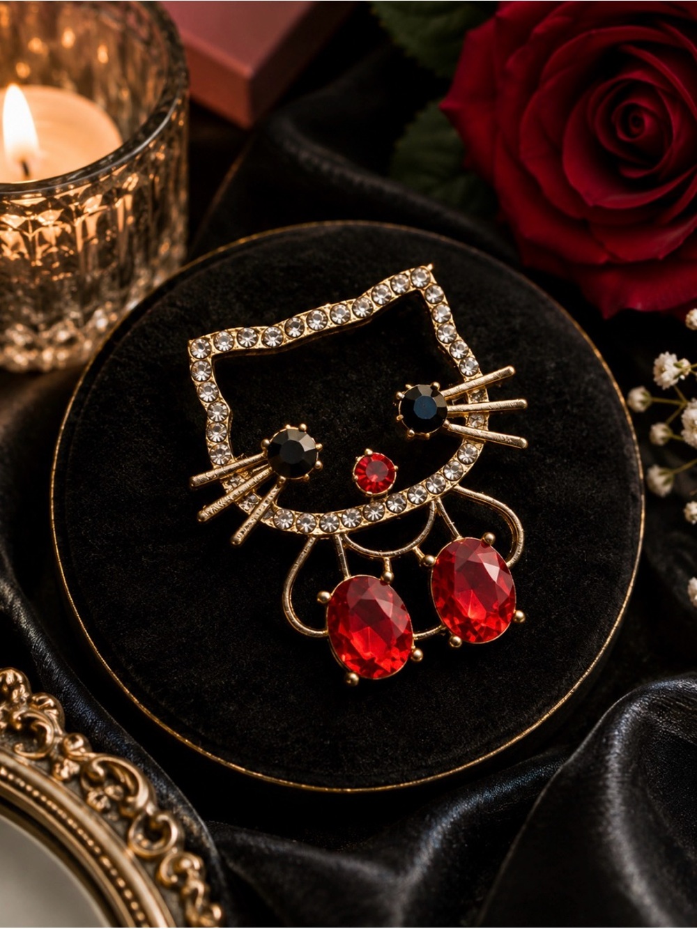Gold-Tone HK Face Brooch with Red Crystal Drops